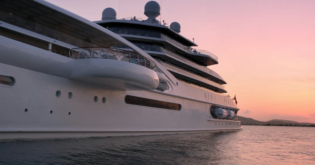 A Celebrity Cruises style ship with a cantilevered deck platform at sunset