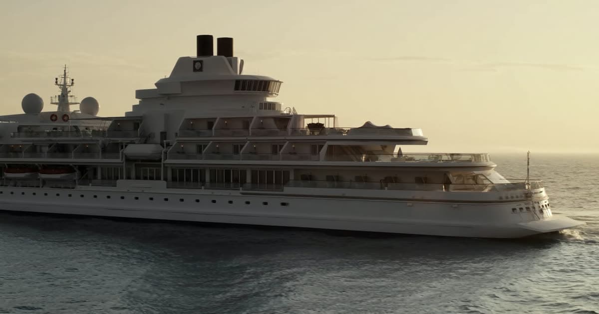An all-suite Regent Seven Seas style ship at sea under a clear evening sky