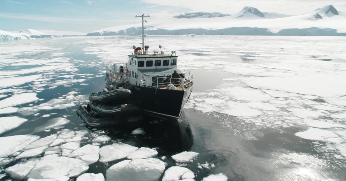 A small ice-strengthened expedition ship among floating ice