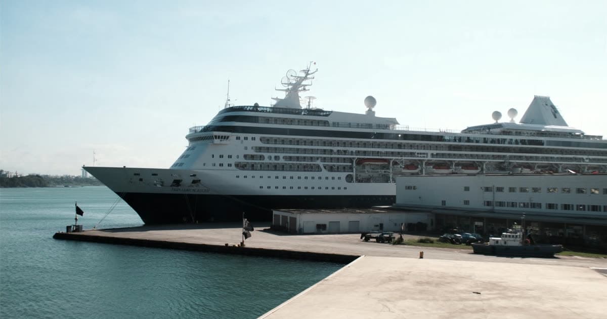 A cruise ship under bright daylight on a calm sea