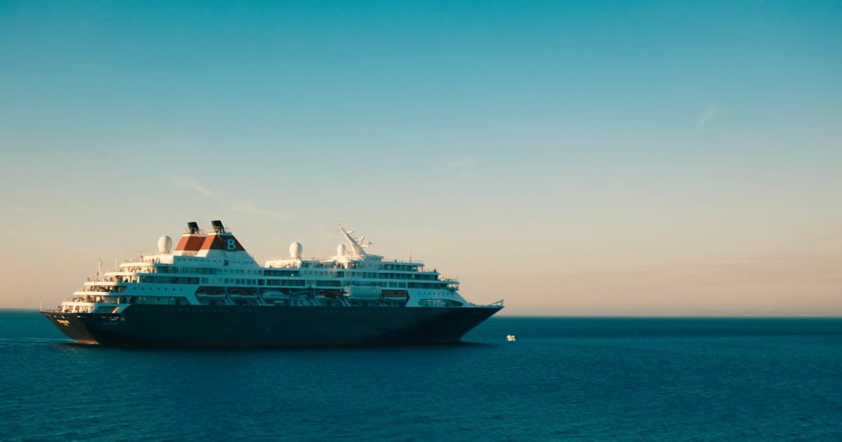 A calm mid-size cruise ship in soft afternoon light