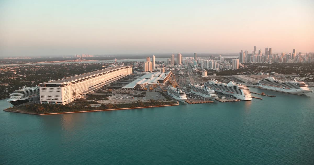 Cruise ships berthed along a Miami terminal island at sunrise
